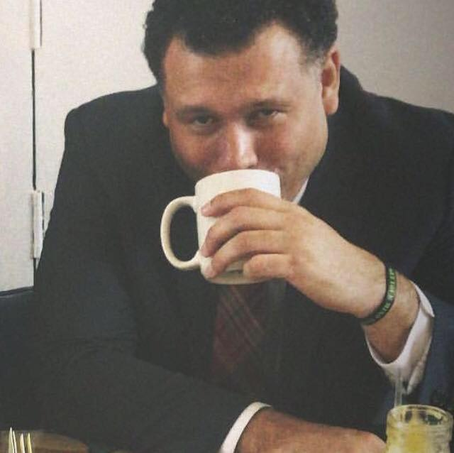 Shawn Walker sipping a cup of coffee.